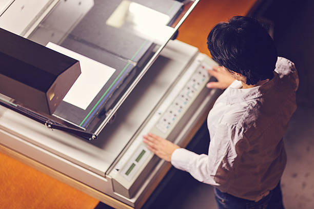 Businesswoman scanning and printing document in office